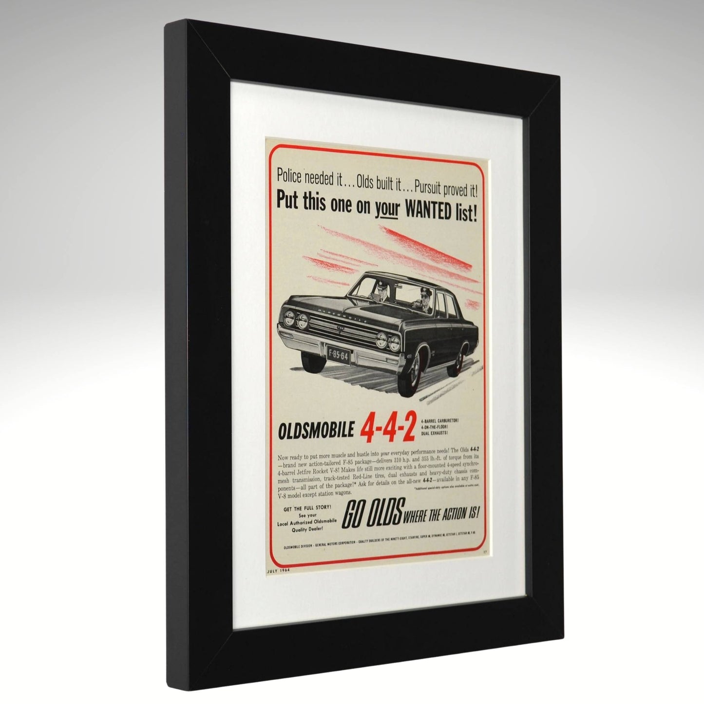 Framed 1964 Oldsmobile 4-4-2 advertisement with black frame