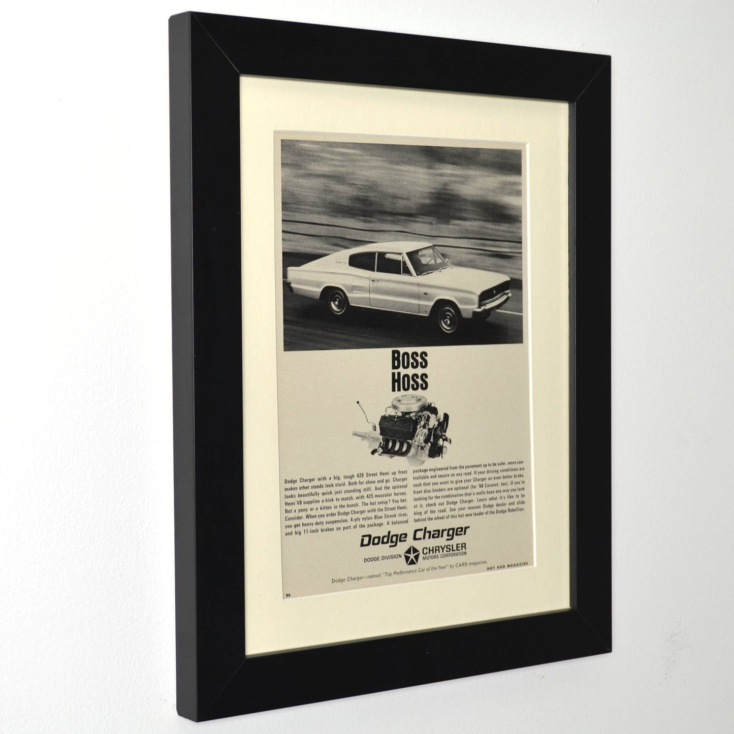 Framed 1966 Dodge Charger 426 HEMI “Boss Hoss” print ad – 12x15 vintage automotive wall art for Mopar enthusiasts and collectors side view