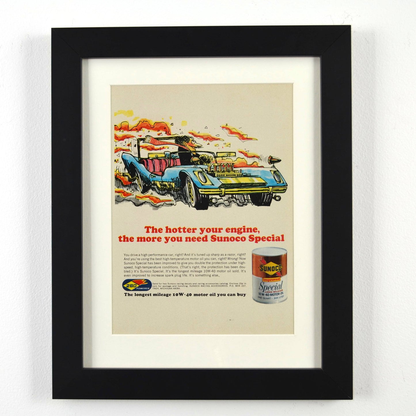 Framed vintage 1967 Sunoco Special oil print ad featuring a bold racing illustration with a high-performance car. Professionally dry mounted and displayed in a 10x13 matte black frame with white matting, showcasing Sunoco branding.