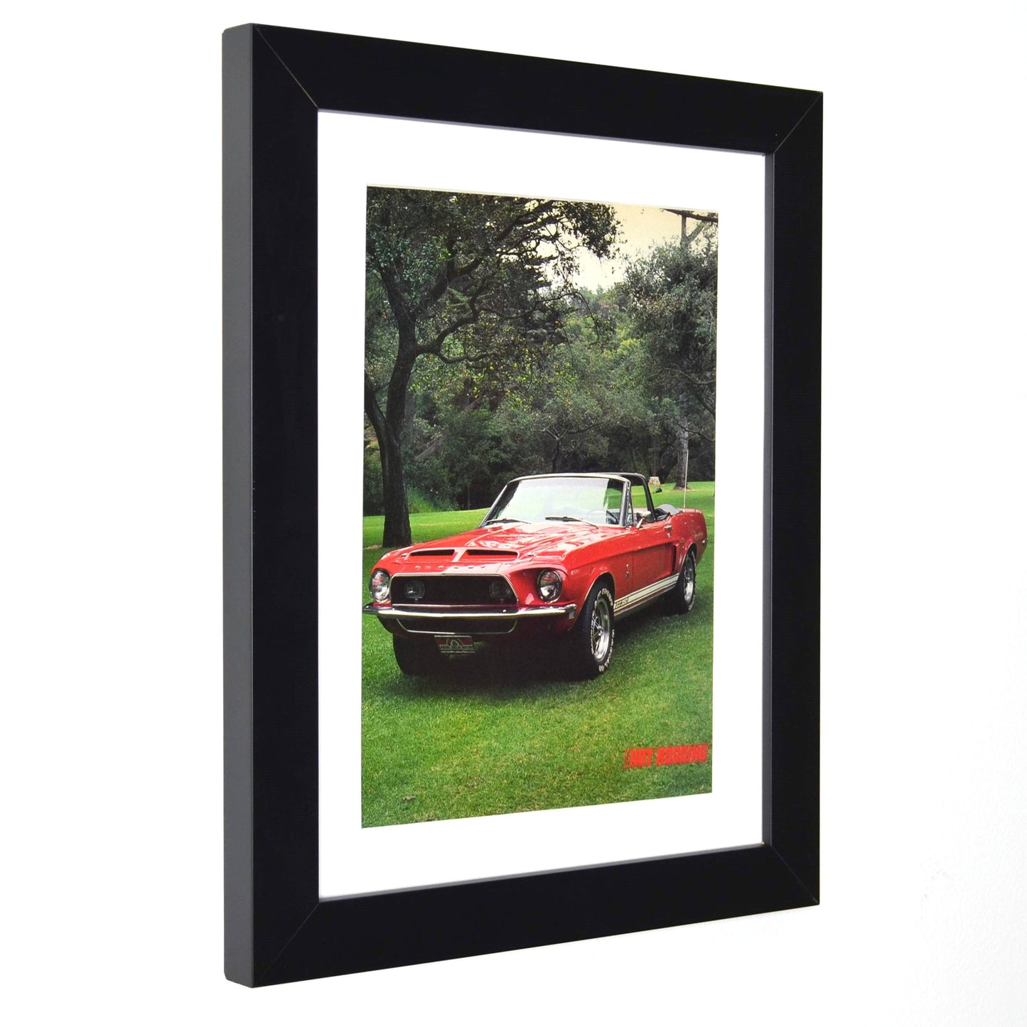 side view of Framed 1968 Shelby GT-350 Convertible vintage print ad, featuring the red Shelby Mustang in a scenic setting, perfect for collectors and classic car enthusiasts.