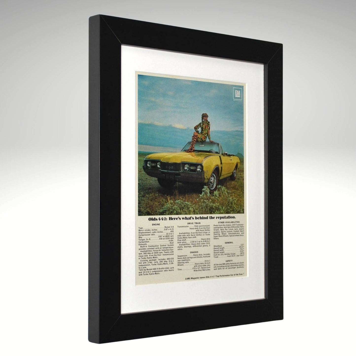 Framed vintage advertisement of a 1968 olds 442 yellow convertible with a person on top, set against a scenic background.