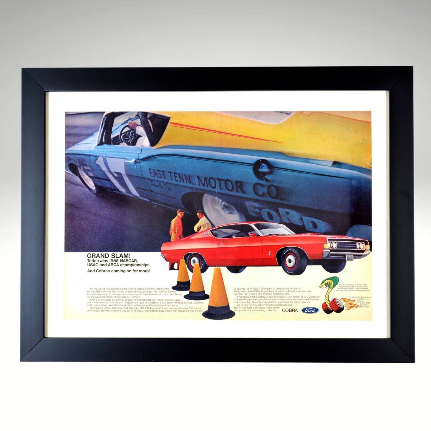 Framed vintage 1968 Ford Torino print featuring a bold red Cobra model in the foreground with NASCAR racing action in the background. The print highlights Ford's success in the 1968 NASCAR, USAC, and ARCA championships, with a blue Torino race car from East Tennessee Motor Co. speeding behind. Includes classic Ford and Cobra logos, evoking the golden era of muscle cars and motorsports. Perfect for collectors and racing enthusiasts.