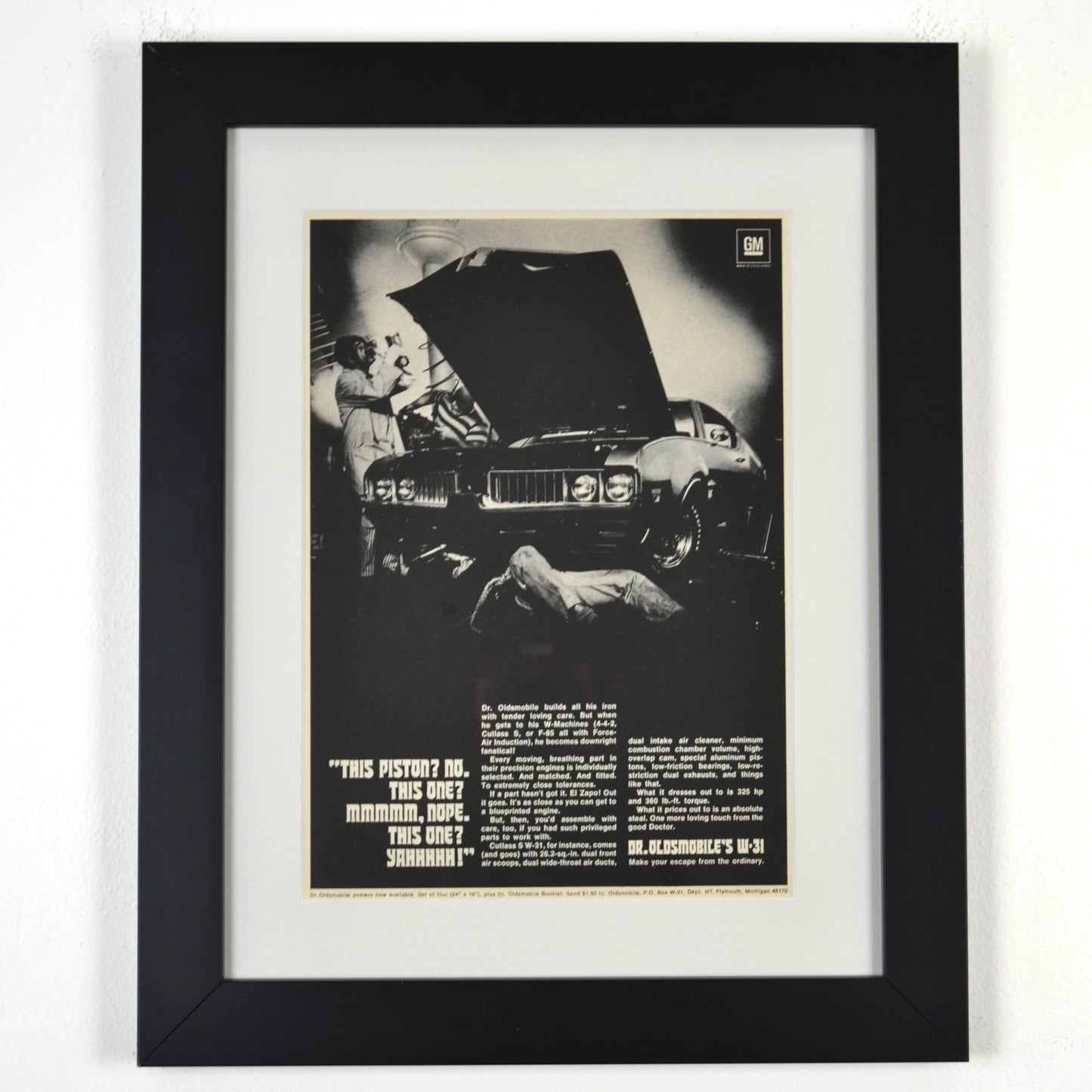 Framed 1969 Oldsmobile W-31 ad print with Dr. Oldsmobile inspecting pistons – 12x15 vintage car wall art