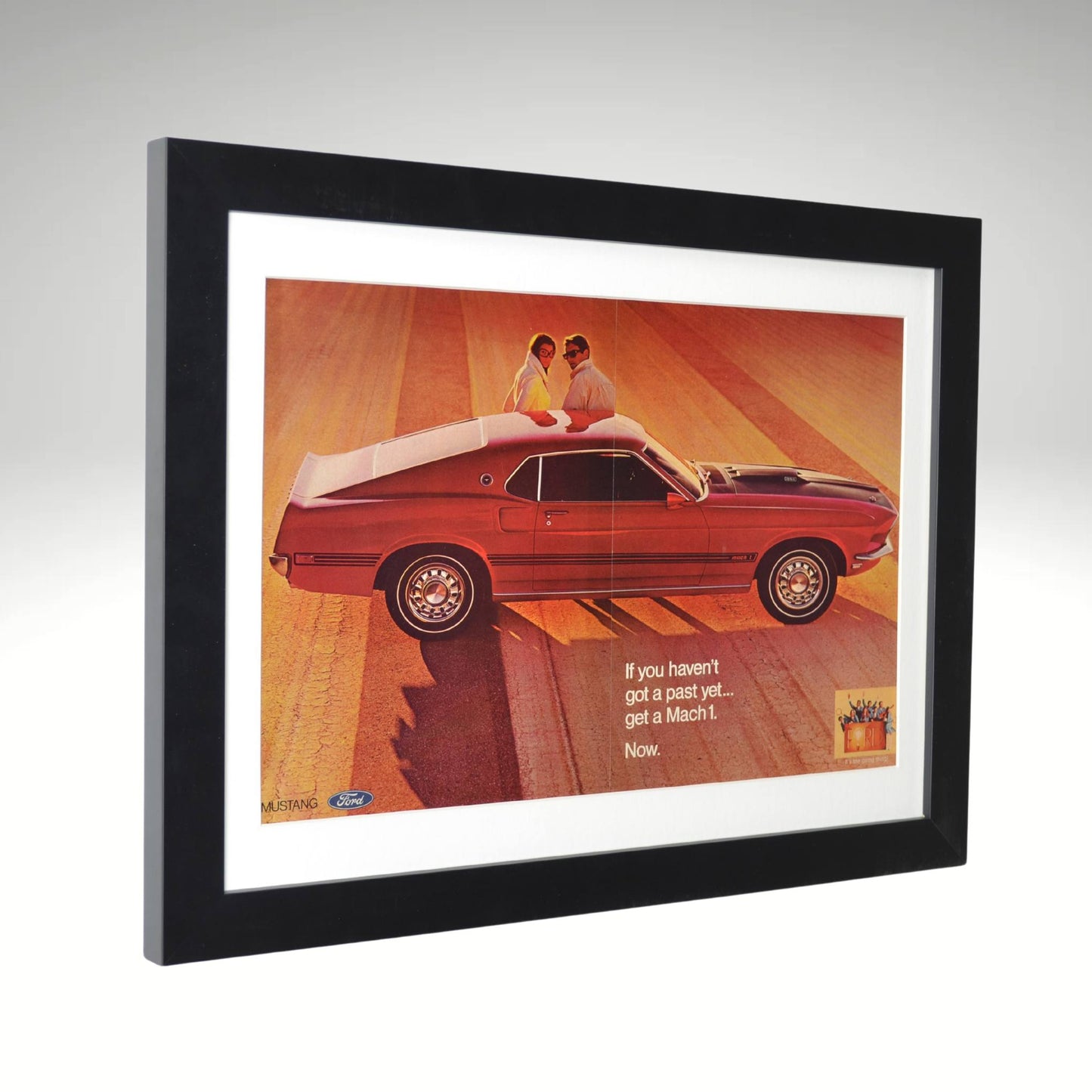 side view of Framed 1969 Ford Mustang Mach 1 vintage print ad featuring bold styling and performance in the golden era of muscle cars.