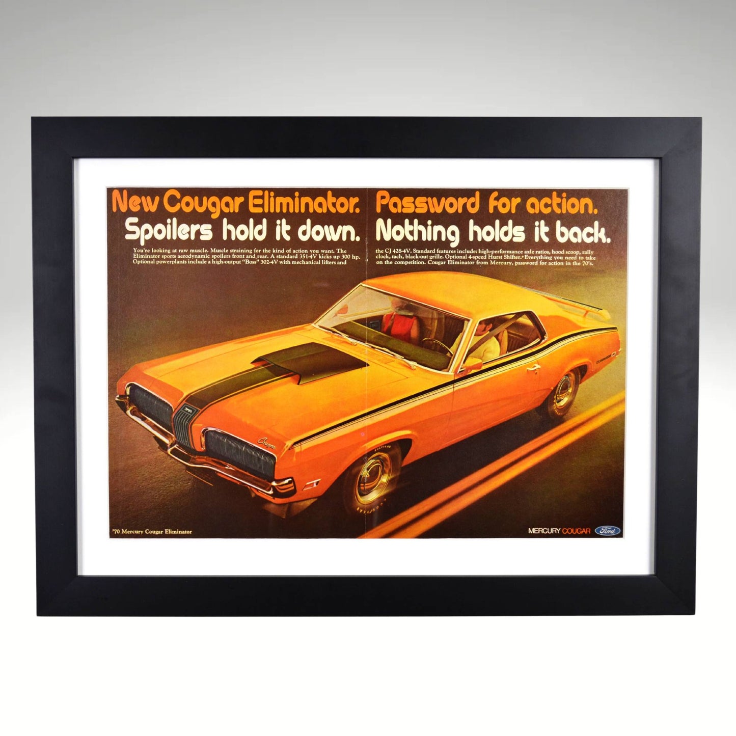 Framed 1970 Mercury Cougar Eliminator vintage ad featuring a bold orange muscle car design with the slogan "Password for action," protected by glass and ready to hang.