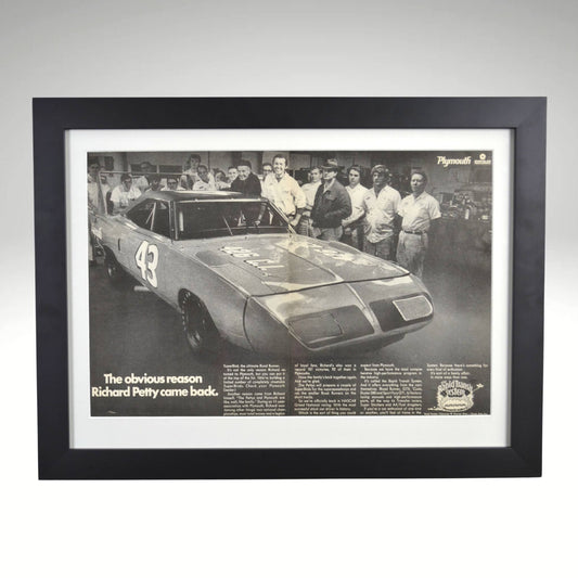 Framed 1970 Richard Petty Plymouth Superbird black and white print featuring the legendary NASCAR driver’s return to Plymouth, displayed in a black frame with glass front.