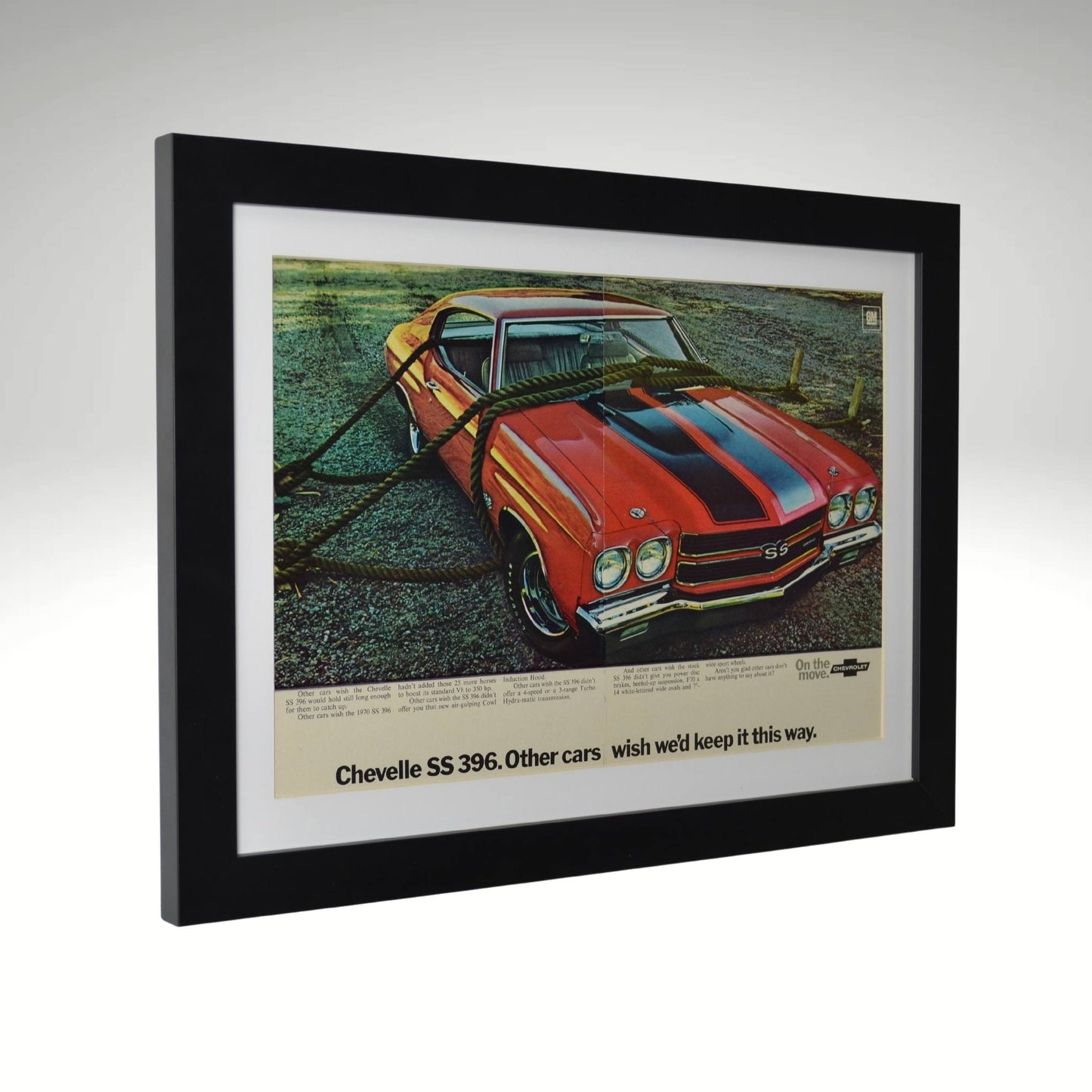Side view of red 1970 Chevrolet Chevelle SS 396 framed vintage print ad featuring the Cowl Induction hood, SS badging, and classic muscle car styling, with authentic centerline misalignment and color shift.