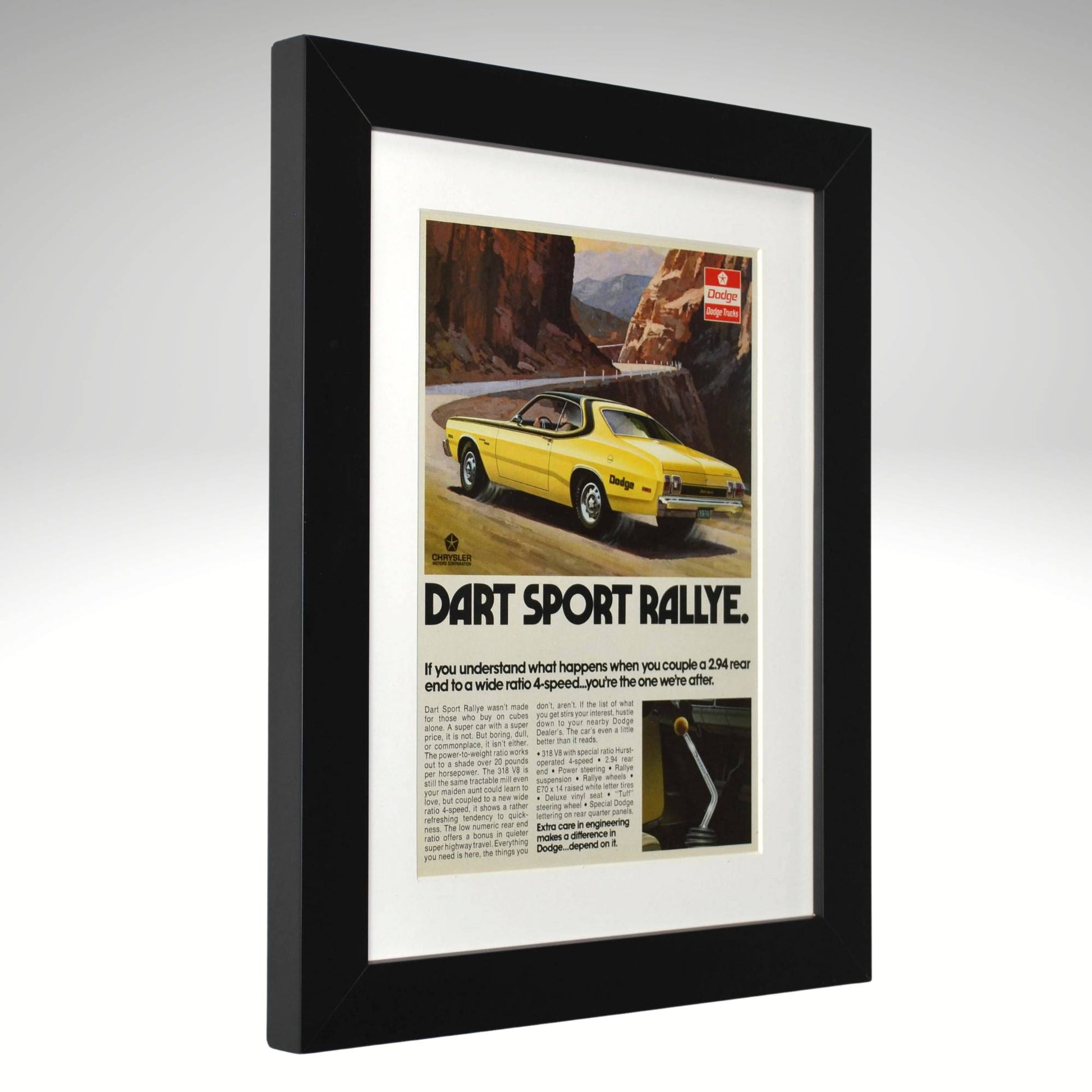 Framed advertisement for a yellow Dart Sport Rallye car on a gray background