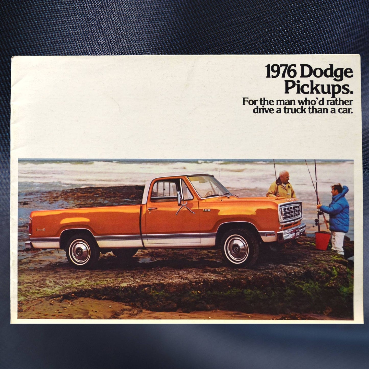 Cover of 1976 Dodge Pickups brochure featuring orange D100