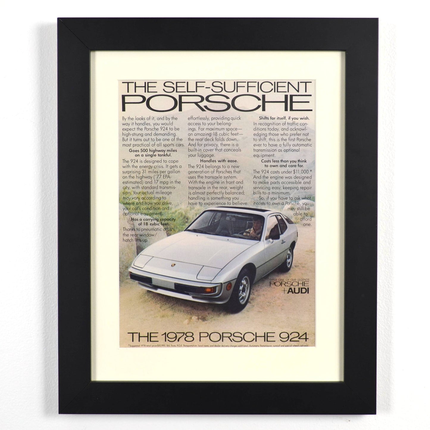 Framed vintage 1978 Porsche 924 print ad featuring silver 924 and retro text layout, dry-mounted and matted in black frame, ready for display.