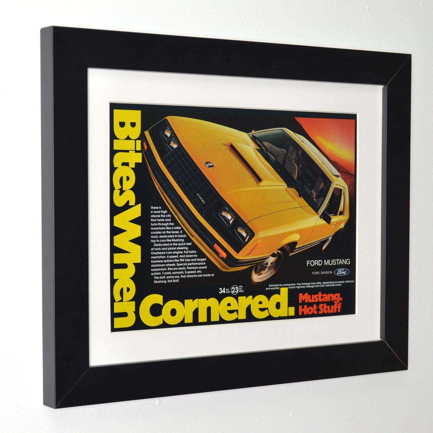 Framed side view of 1981 Ford Mustang vintage print ad, featuring a bold yellow and black Mustang with the slogan "Bites When Cornered", perfect for collectors.