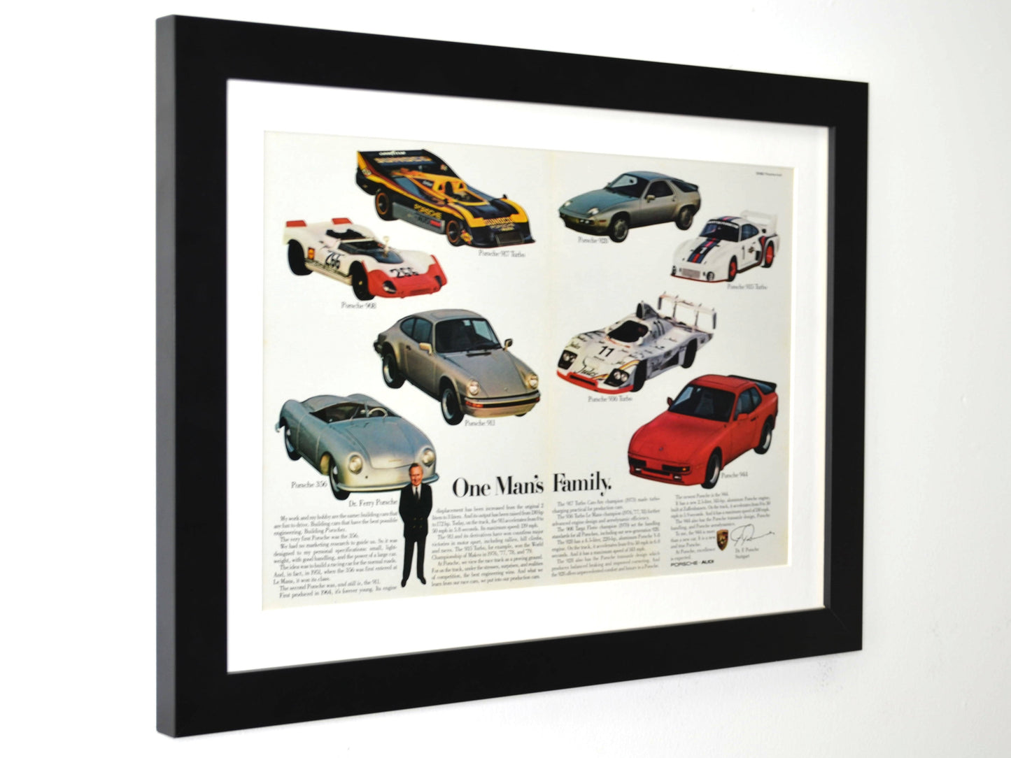 Framed 15x20 vintage Porsche print showing 1982 ad with 356, 911, 917, 928, 944, and more under the title “One Man’s Family”side view