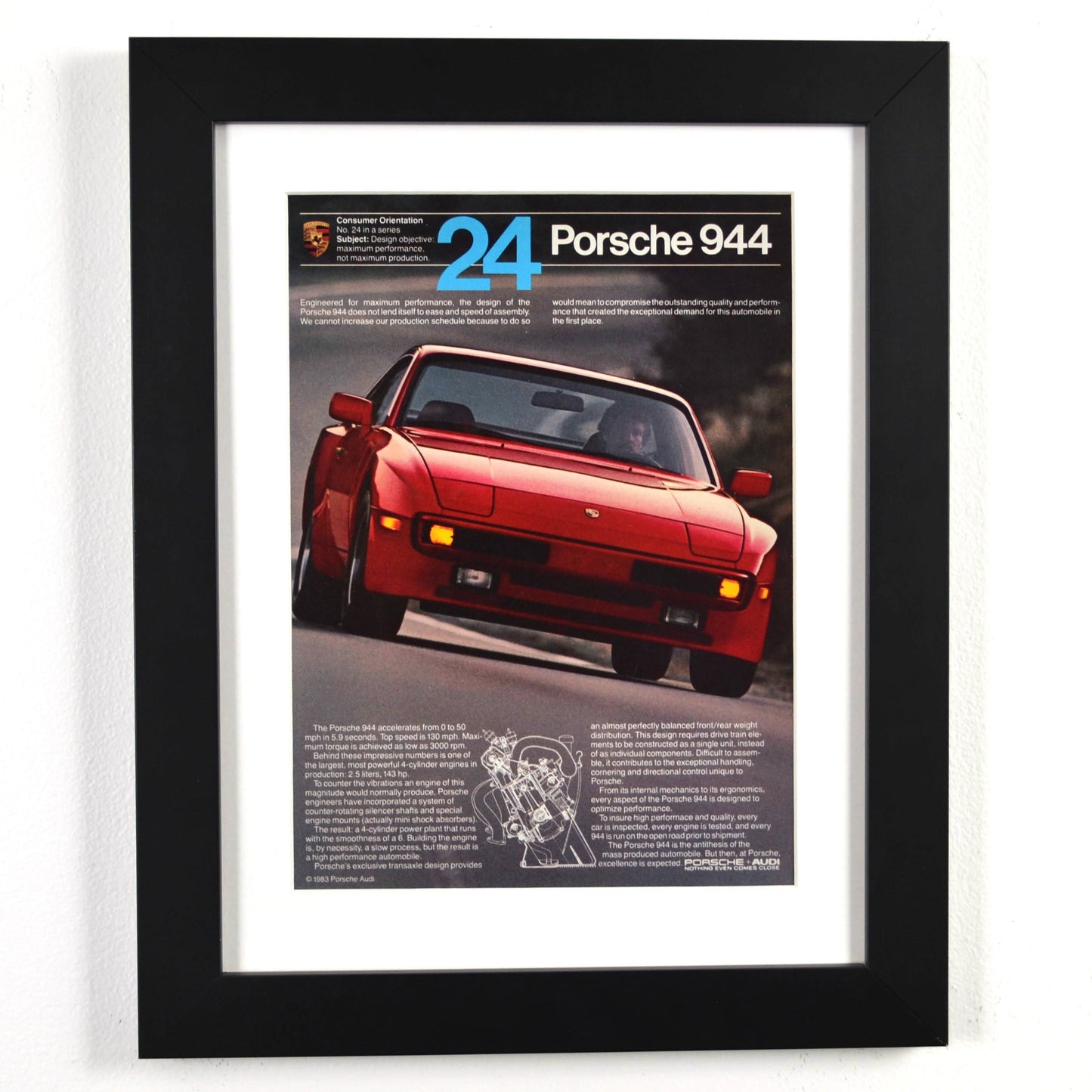 Framed 1983 Porsche 944 print ad with red 944 and cutaway diagram – vintage automotive wall art with new frame, mat, and glass
