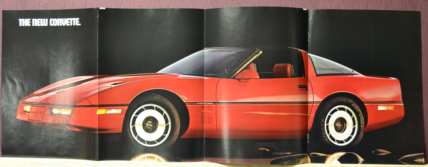 Side profile of red 1984 Corvette C4 with bold “The New Corvette” headline – unfolded trifold ad poster