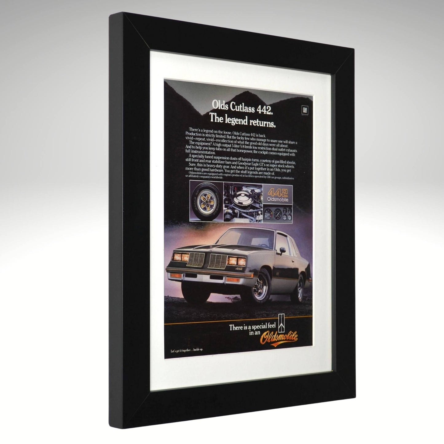 Framed advertisement for 1984 Oldsmobile 442 classic car with text and images on a gray background