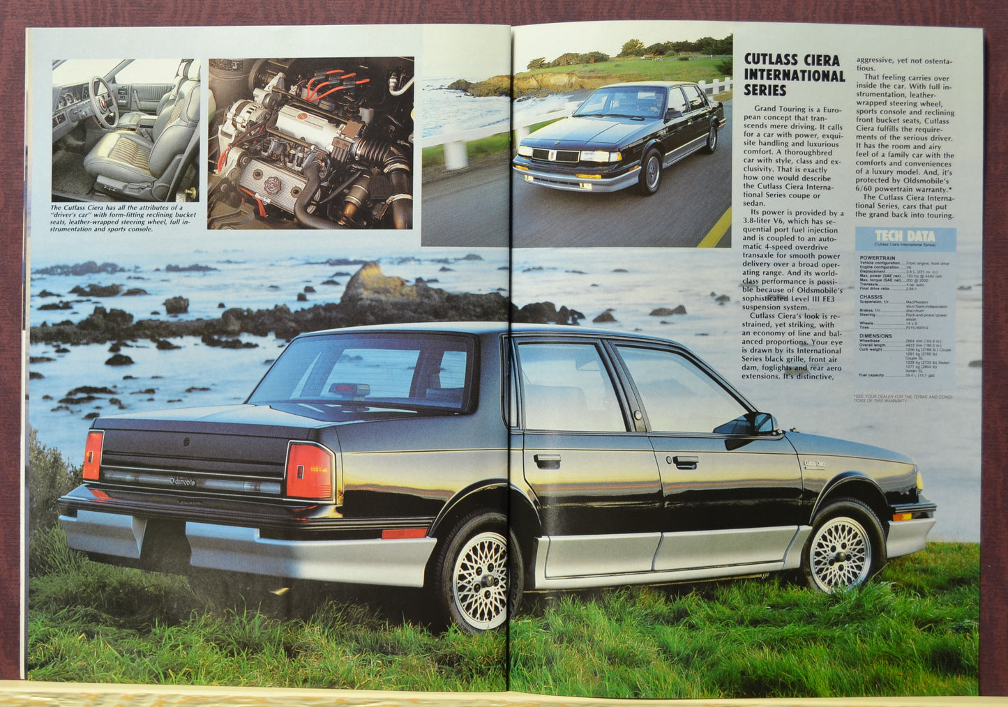 1988 Black Oldsmobile Cutlass Ciera International Series brochure spread – ocean background with interior and engine shots