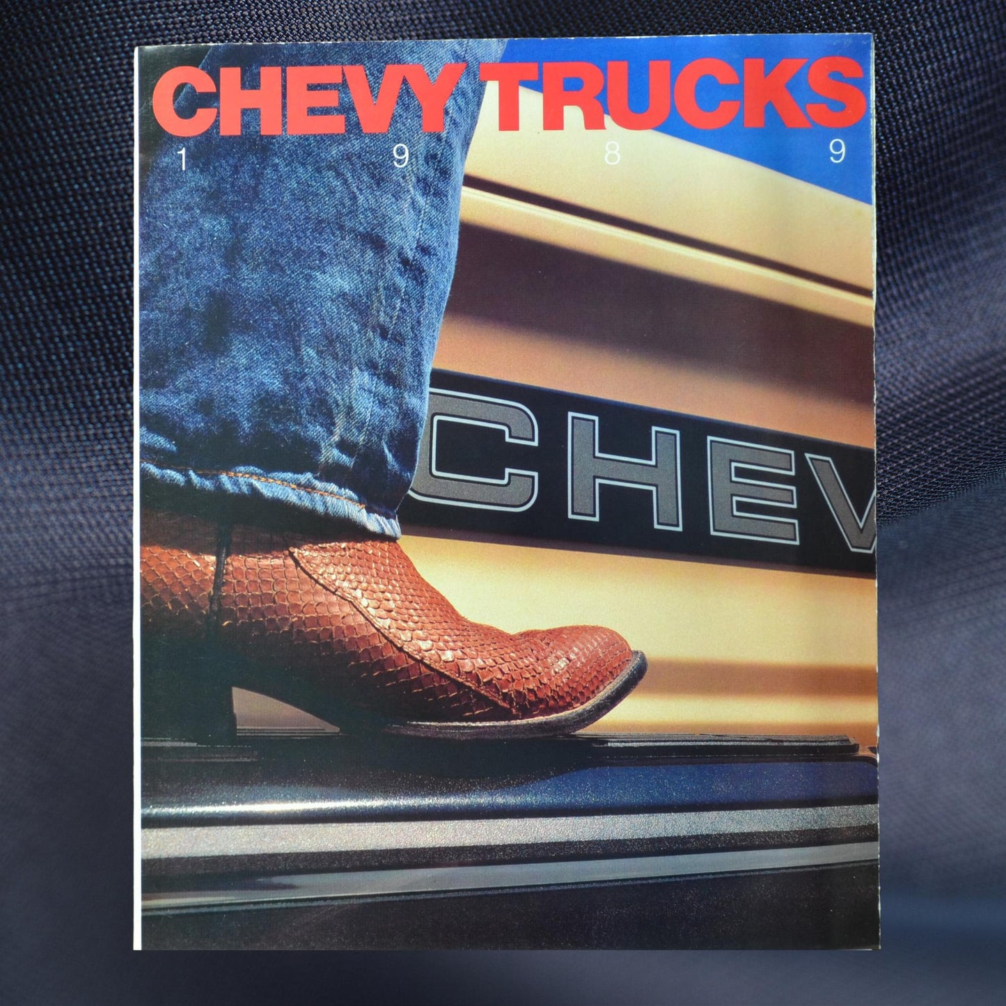 Cover image of the 1989 Chevy Trucks dealer brochure with a close-up of a cowboy boot resting on a Chevy tailgate.