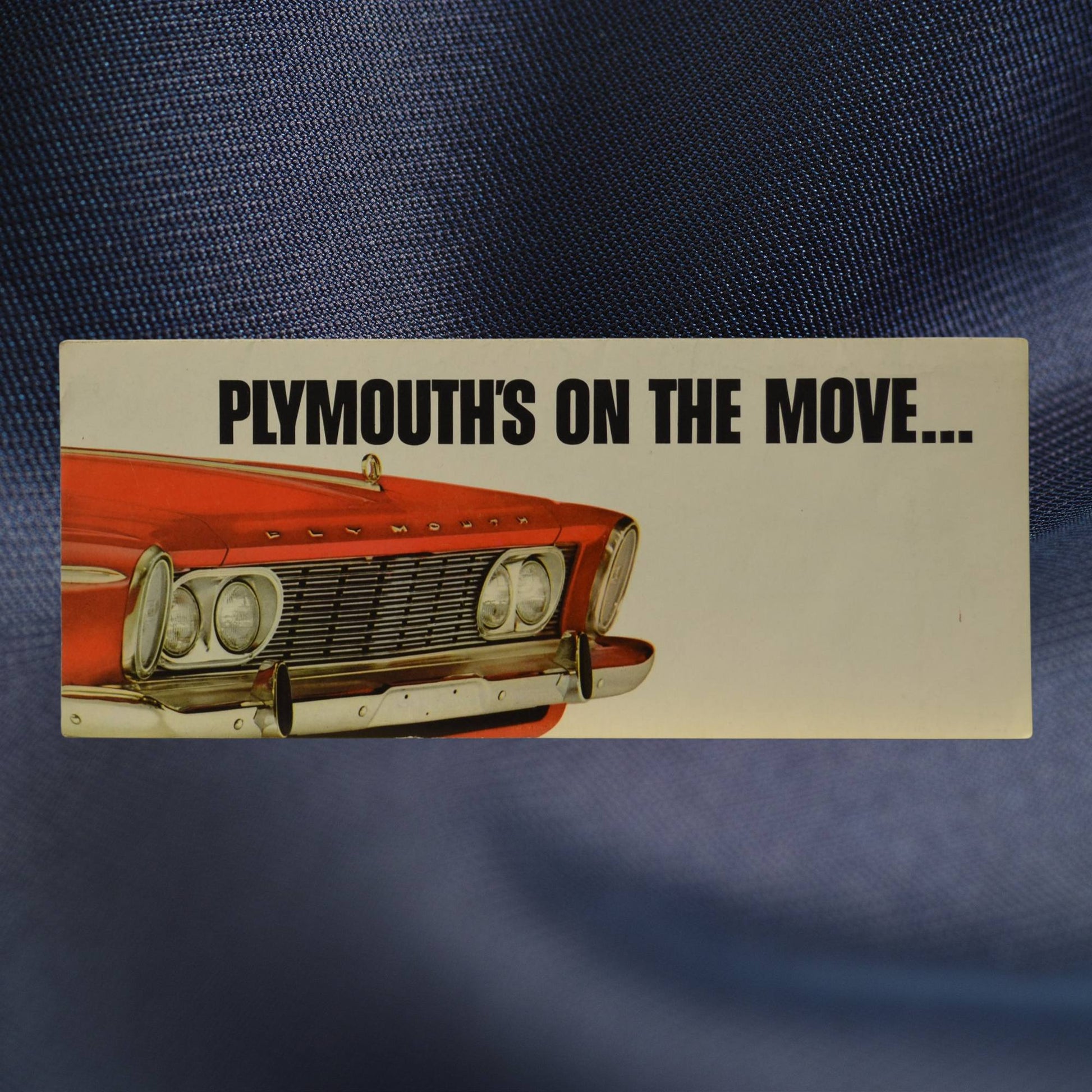 1963 Plymouth brochure front cover – On the Move slogan with red car