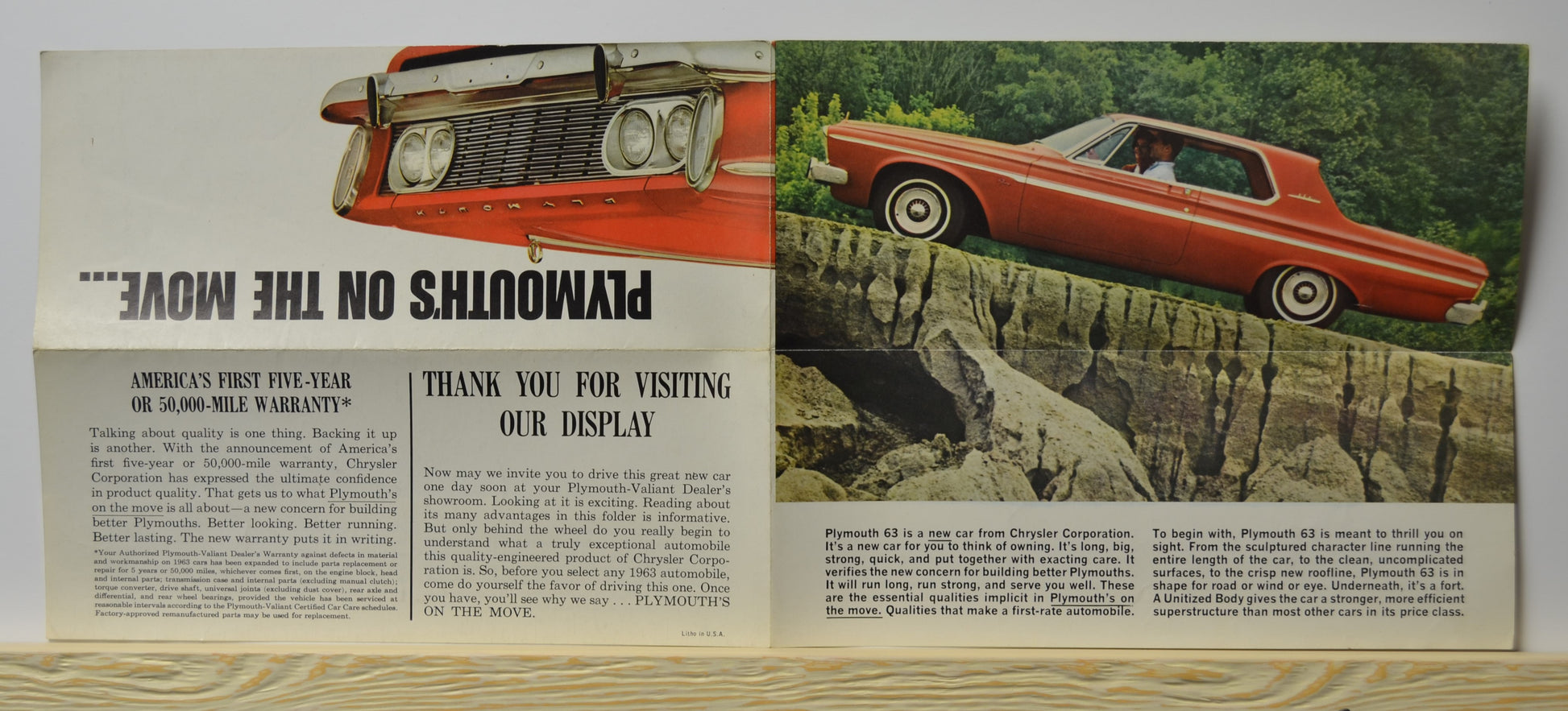 1963 Plymouth brochure unfolded – red Sport Fury on cliff