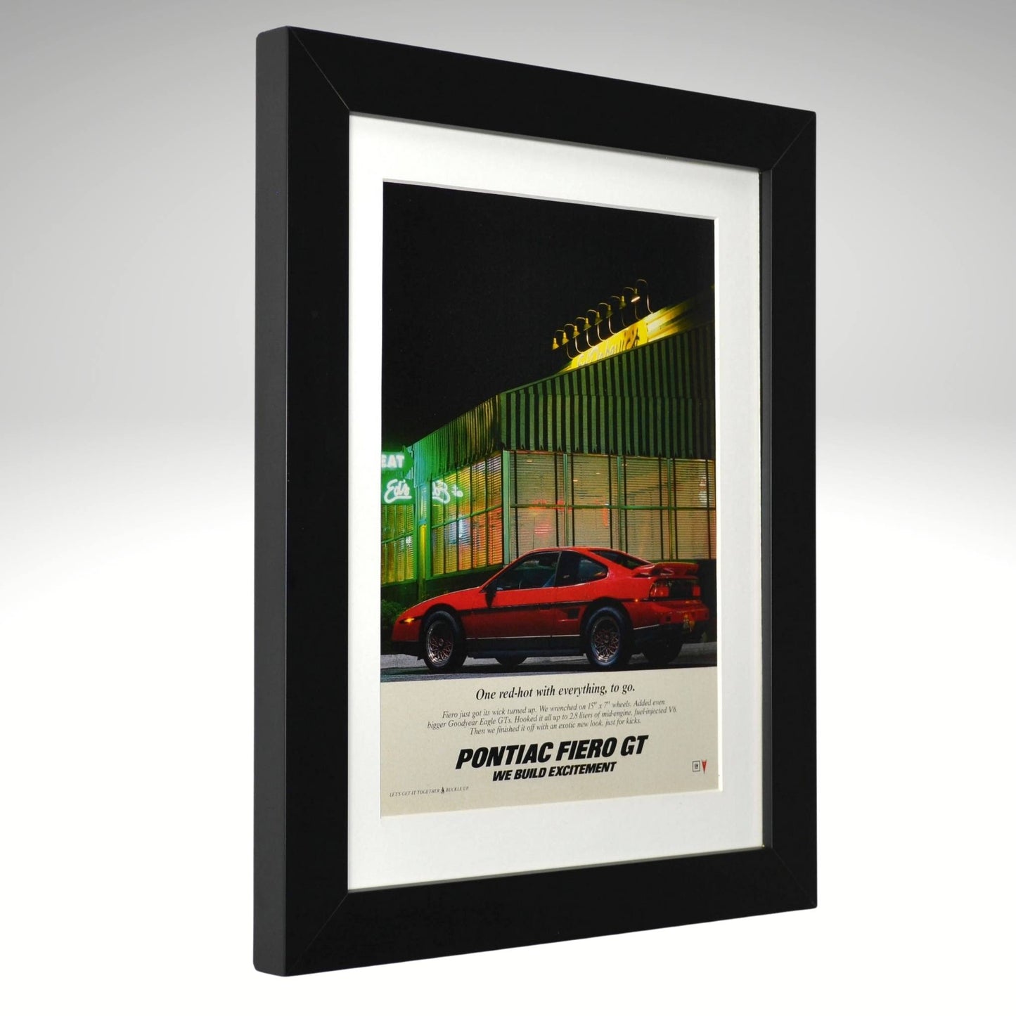Framed poster of a red Pontiac Fiero GT car with a black frame.