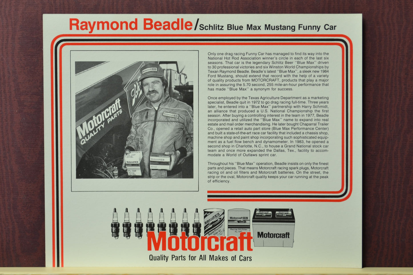 1983 Raymond Beadle Blue Max Funny Car hero card featuring a black-and-white image of Beadle holding Motorcraft parts, with his Mustang Funny Car in the background