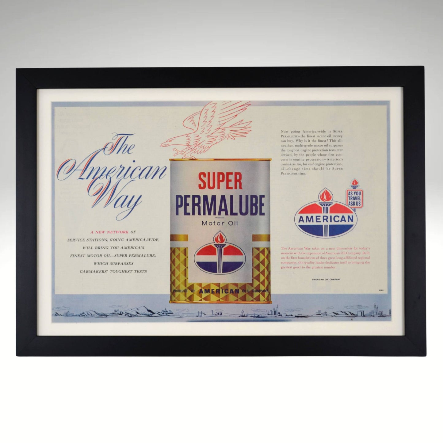 961 American Oil Super Permalube framed vintage print featuring a patriotic-themed gas and oil advertisement with the classic American Oil torch logo, dry-mounted and displayed in a black wood frame with a white matte. Ideal petroliana wall art for collectors and vintage gas station memorabilia enthusiasts