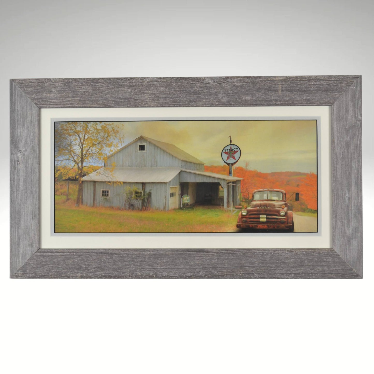 Vintage Texaco Station Framed Wall Art – Rustic barn with a weathered Texaco gas station sign and an old Chevrolet truck parked out front, set against a backdrop of vibrant autumn foliage, framed in reclaimed wood for a classic country aesthetic