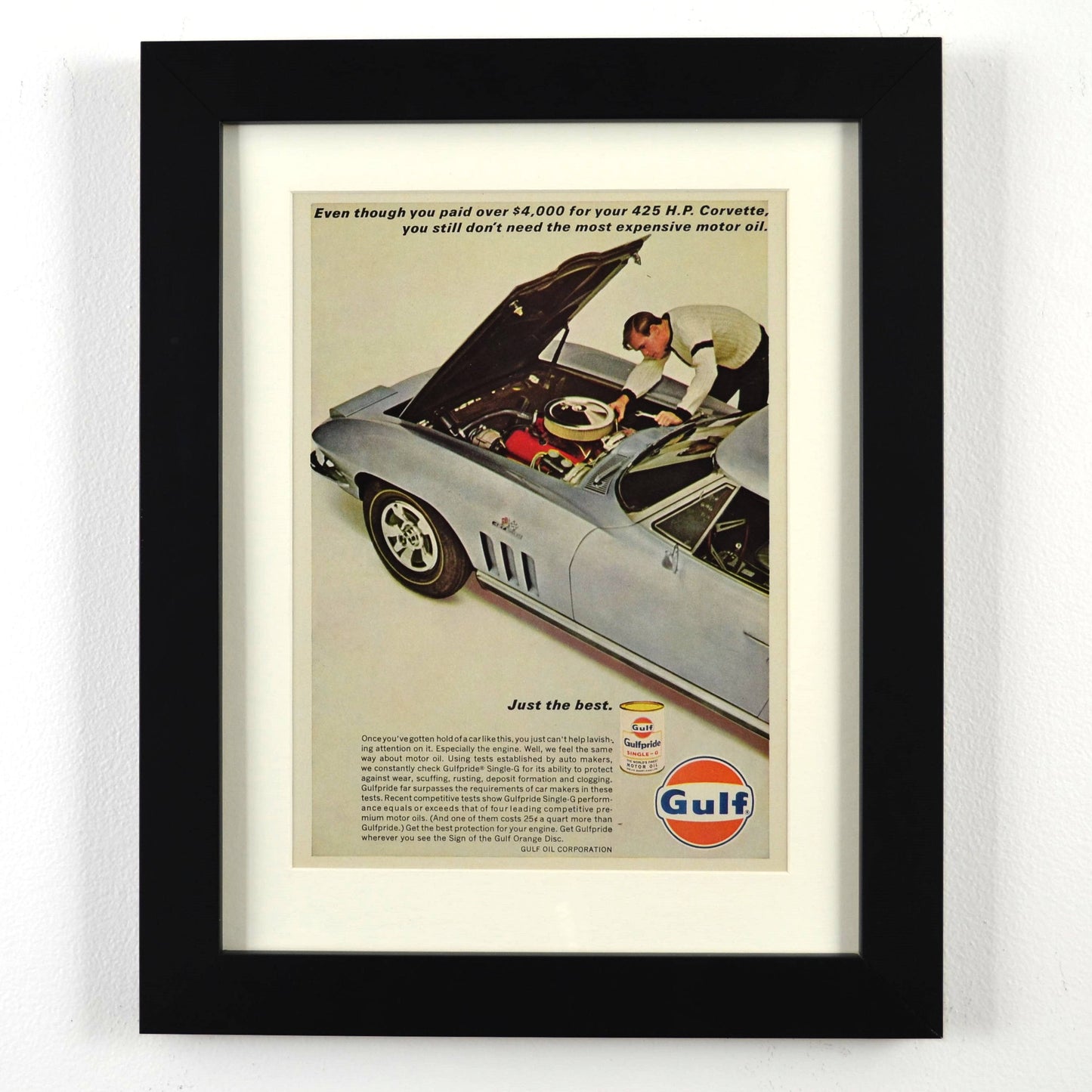 Framed vintage 1967 Gulf Oil print ad featuring a Chevrolet Corvette 427. Professionally dry mounted and displayed in a 10x13 matte black frame with white matting, showcasing Gulf’s high-performance motor oil branding.