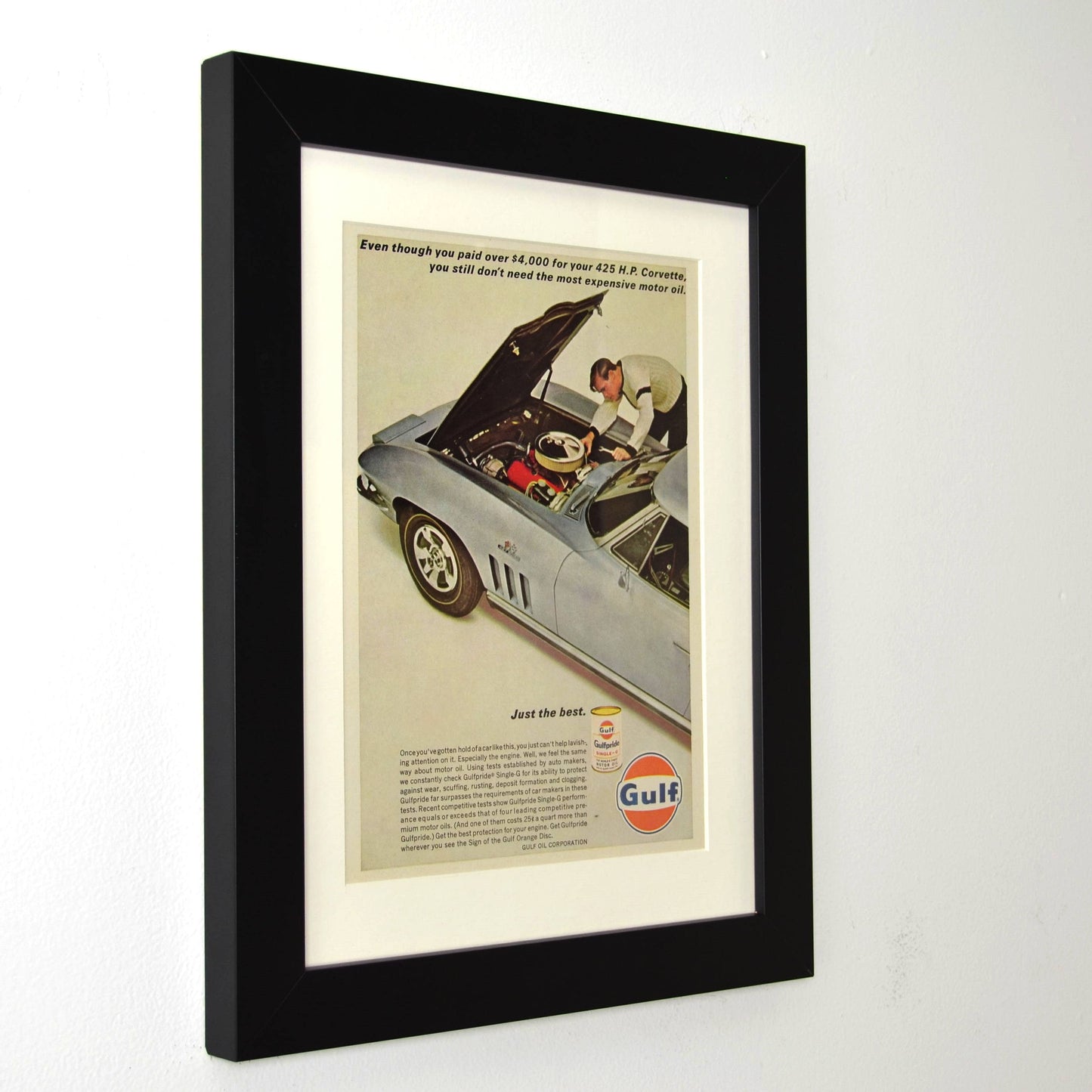 Framed vintage 1967 Gulf Oil print ad featuring a Chevrolet Corvette 427. Professionally dry mounted and displayed in a 10x13 matte black frame with white matting, showcasing Gulf’s high-performance motor oil branding side view