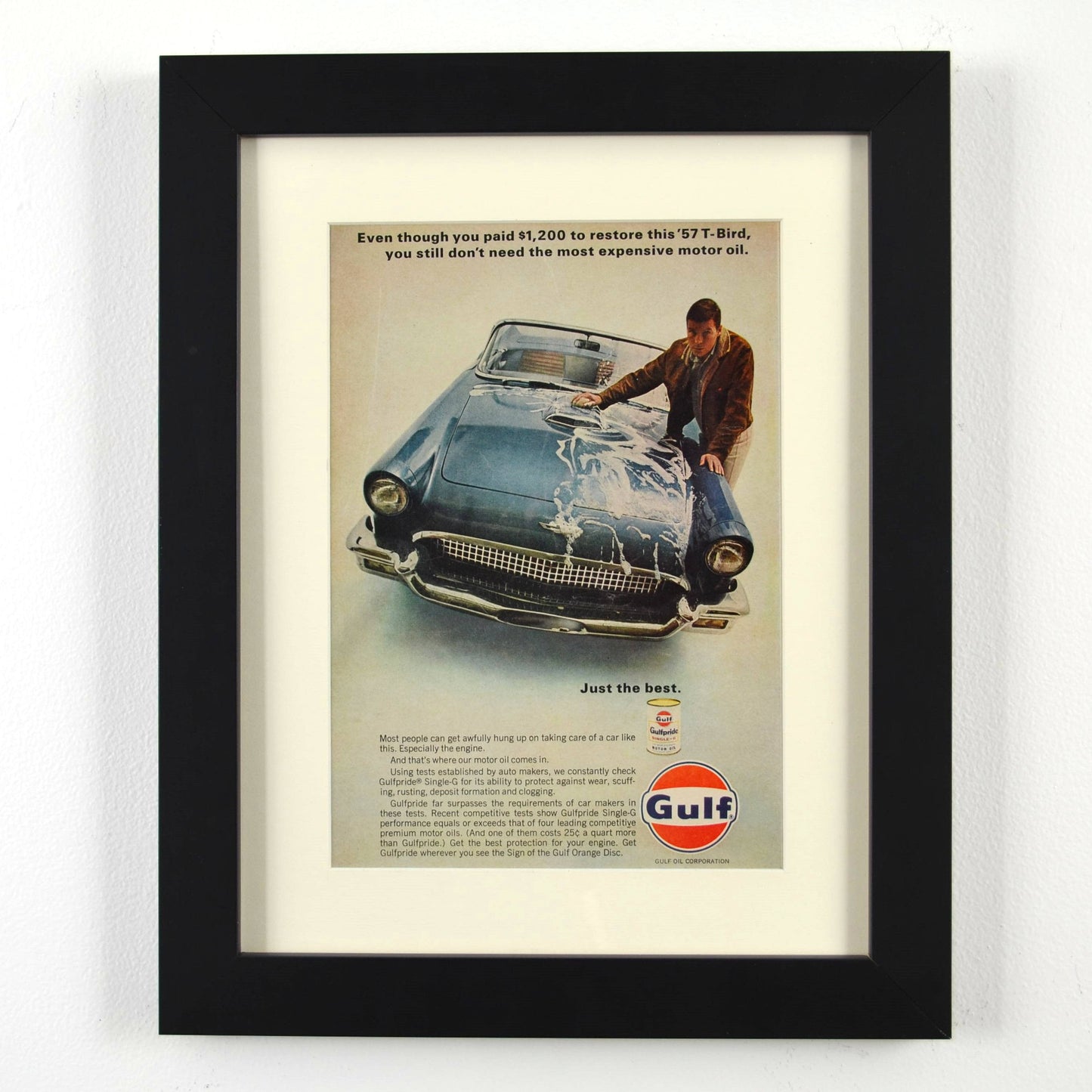 Framed vintage Gulf Oil print ad featuring a 1957 Ford Thunderbird. Professionally dry mounted and displayed in a 10x13 matte black frame with white matting, showcasing Gulfpride motor oil branding and a classic T-Bird restoration theme.