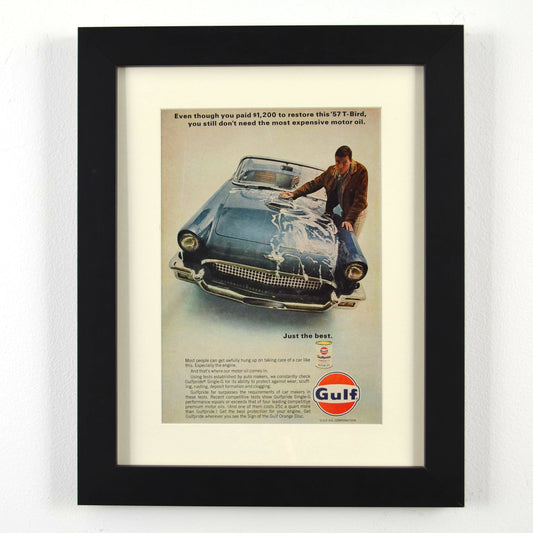Framed vintage Gulf Oil print ad featuring a 1957 Ford Thunderbird. Professionally dry mounted and displayed in a 10x13 matte black frame with white matting, showcasing Gulfpride motor oil branding and a classic T-Bird restoration theme.