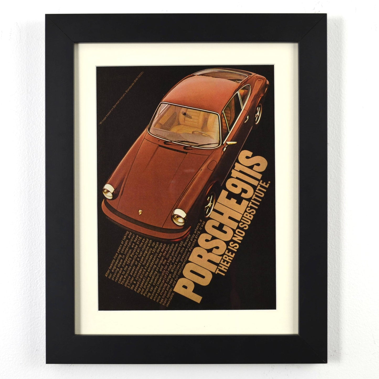 Framed vintage Porsche 911S print ad featuring the classic air-cooled sports car. Professionally dry mounted and displayed in a 10x13 matte black frame with white matting, ready for wall display.