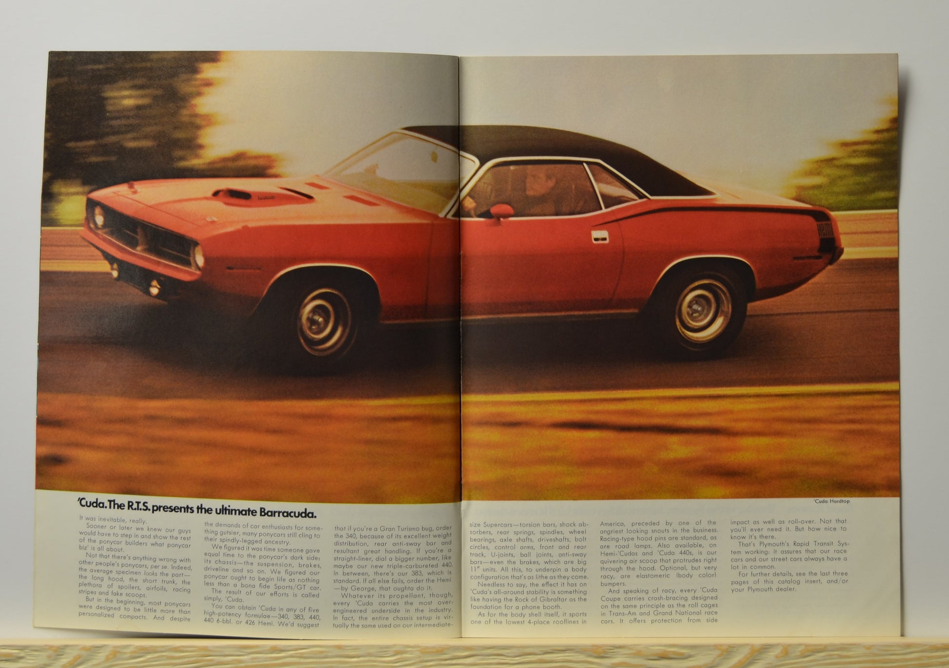 Interior spread featuring red Plymouth ’Cuda with vinyl top