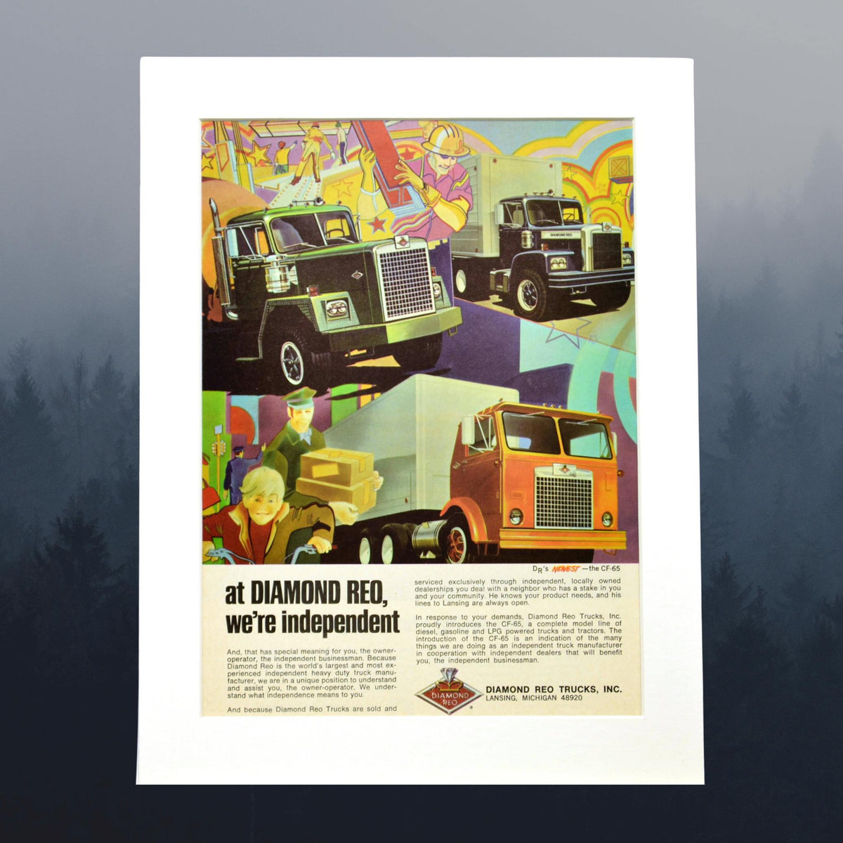Framed vintage Diamond Reo truck advertisement featuring classic semi-trucks in a colorful illustrated scene. A must-have for trucking enthusiasts and collectors.