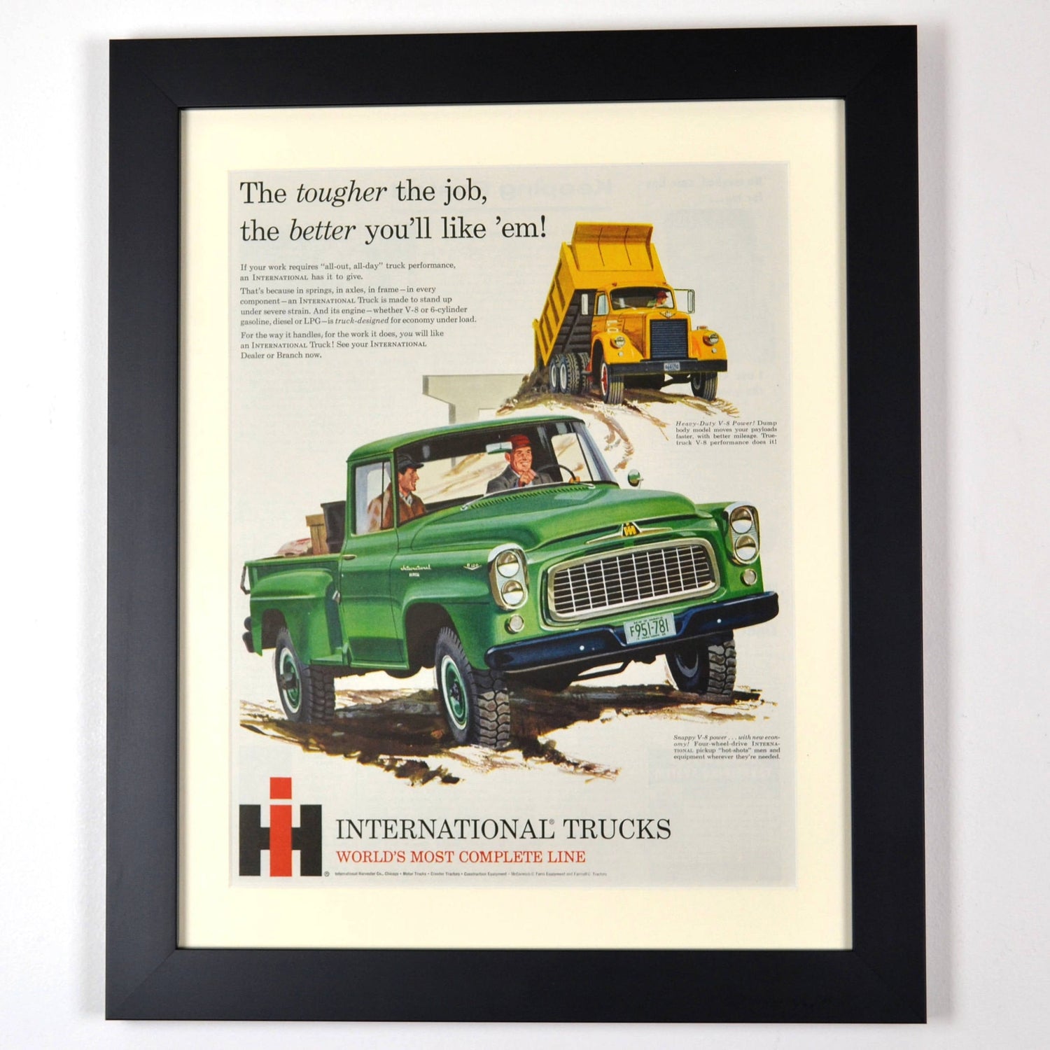 Framed vintage International Harvester truck advertisement featuring a classic green IH pickup and a yellow dump truck. A nostalgic tribute to work trucks and heavy haulers