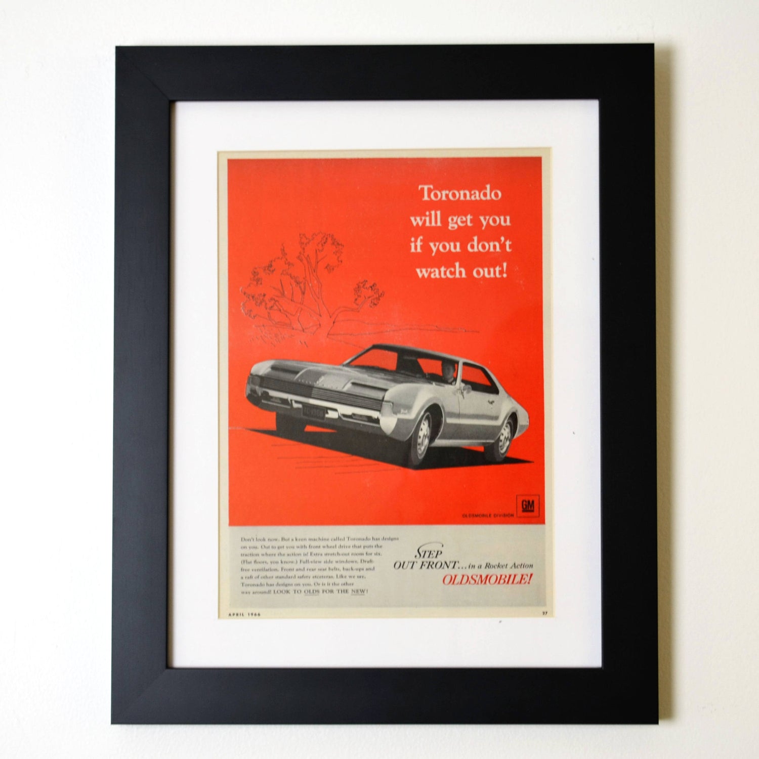 Framed vintage 1970 Oldsmobile 442 advertisement featuring a bright red muscle car at a trackside testimonial dinner. A must-have for classic car collectors