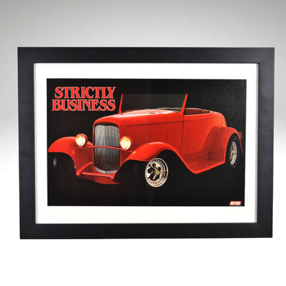 Framed poster of a 1932 Ford Hot Rod titled "Strictly Business," from a Hot Rod Magazine centerfold, featuring a bold red car in a sleek black frame.