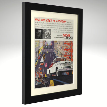 Framed vintage advertisement for Dodge Trucks on a gray background