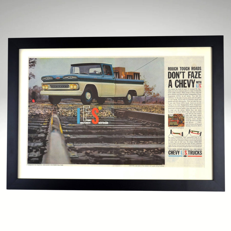 1961 Chevrolet truck framed vintage print featuring a two-tone Chevy pickup conquering railroad tracks, showcasing Independent Front Suspension technology.