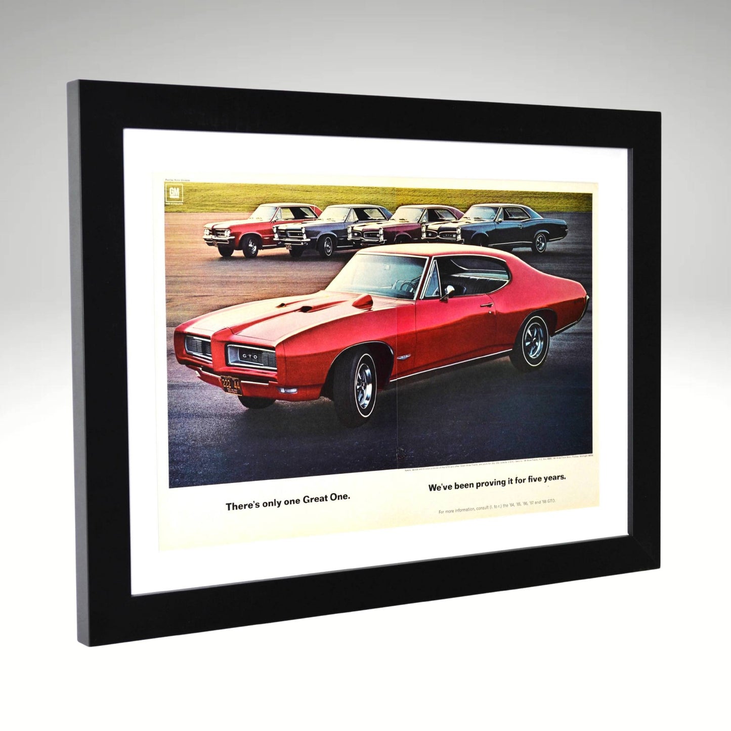 Framed 1968 Pontiac GTO ad featuring 1964–1968 lineup and “Great One” slogan side view

