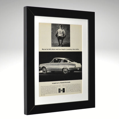 Framed vintage advertisement for a Plymouth Barracuda car with a black border.