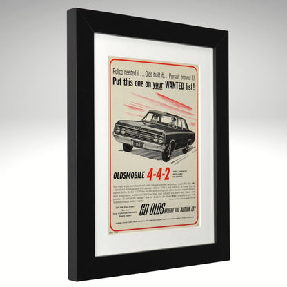 Framed 1964 Oldsmobile 4-4-2 advertisement with black frame