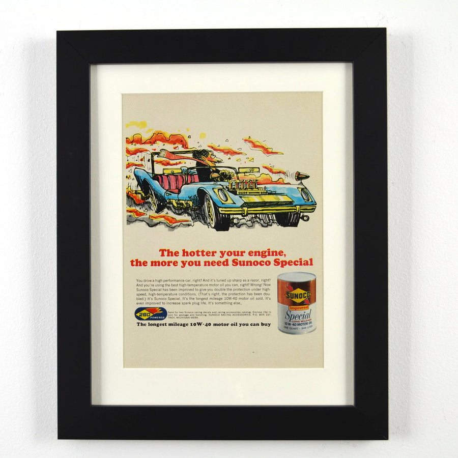 Framed vintage 1967 Sunoco Special oil print ad featuring a bold racing illustration with a high-performance car. Professionally dry mounted and displayed in a 10x13 matte black frame with white matting, showcasing Sunoco branding.