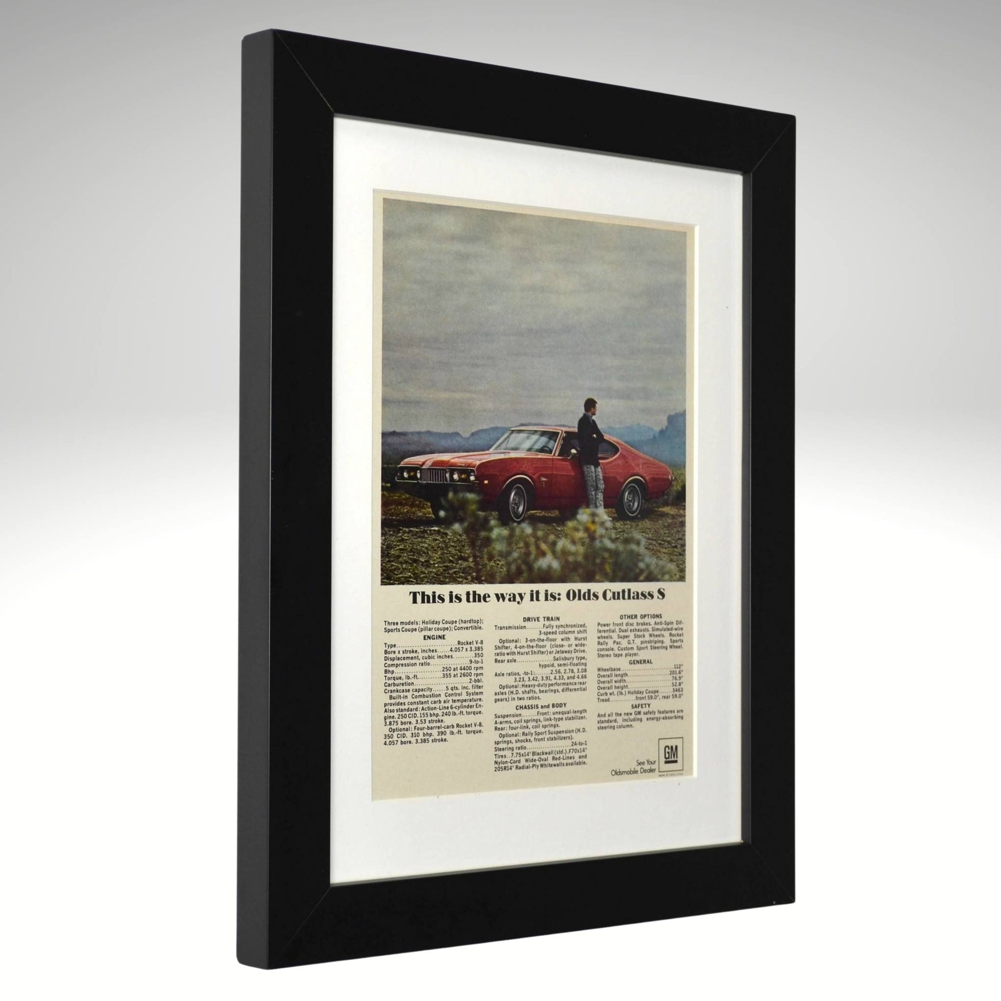 Framed vintage advertisement for Olds Cutlass S with a black frame.