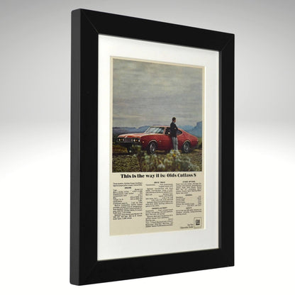 Framed vintage advertisement for Olds Cutlass S with a black frame.