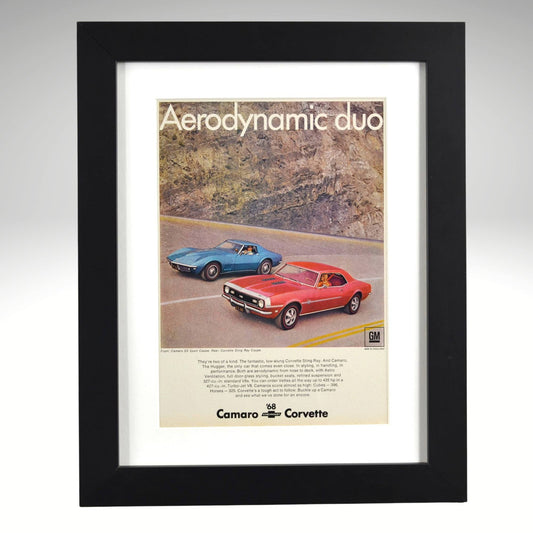 Framed advertisement featuring 1968 Camaro and Corvette cars on a road with 'Aerodynamic duo' text.