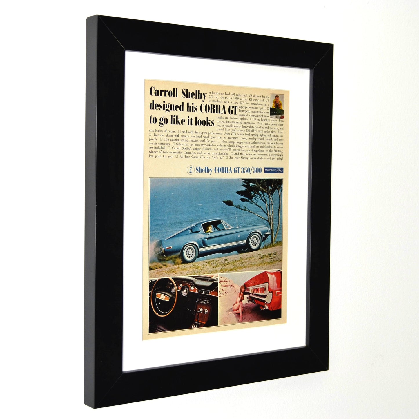 Side view of Framed 1968 Shelby Cobra GT-350/500 vintage print ad, featuring the blue fastback Shelby Mustang on a scenic coastal road, perfect for collectors and classic car enthusiasts.