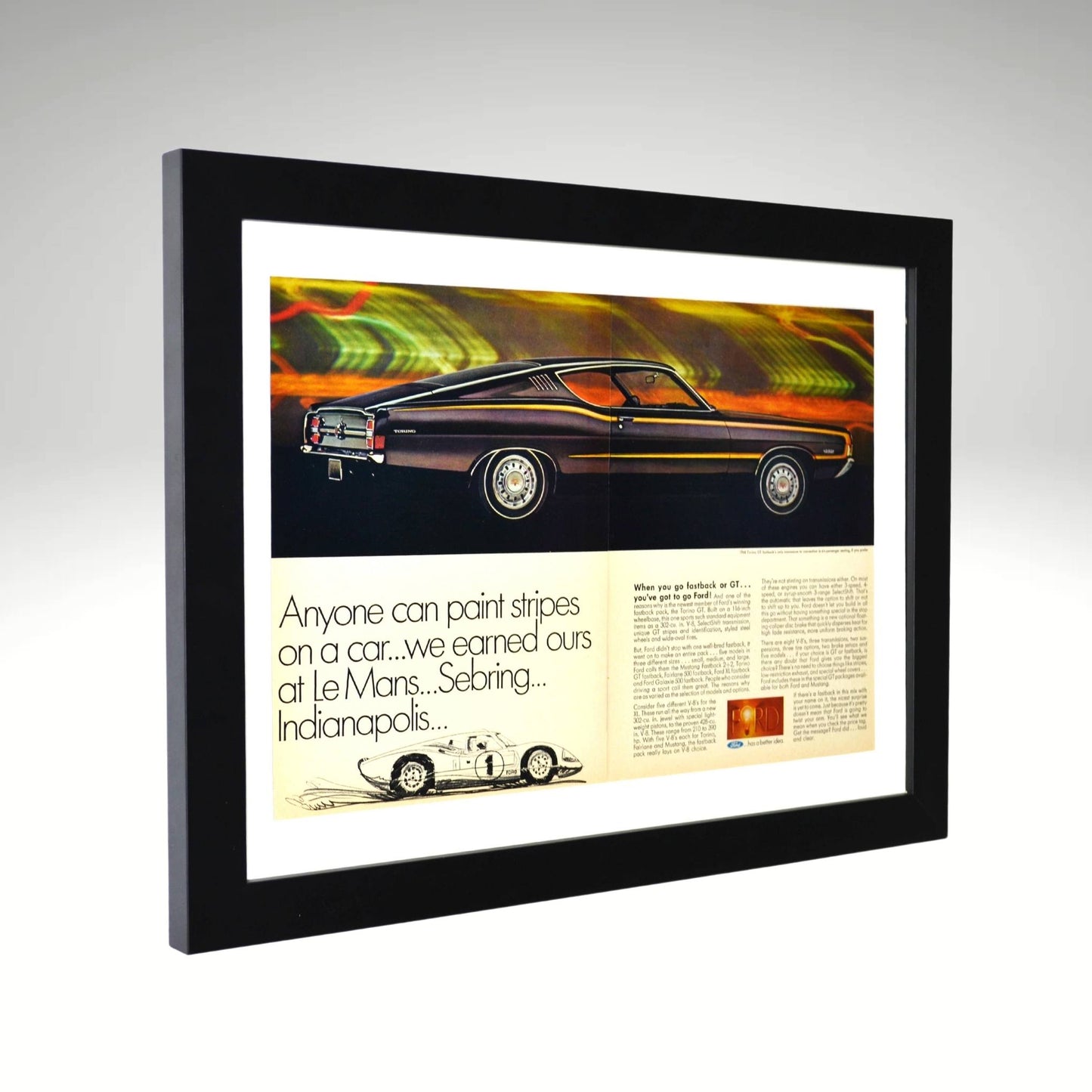 side view of Framed 1968 Ford Torino GT Fastback print ad featuring the sleek muscle car and a nod to Ford’s GT-40 racing legacy at Le Mans, Sebring, and Indianapolis.

