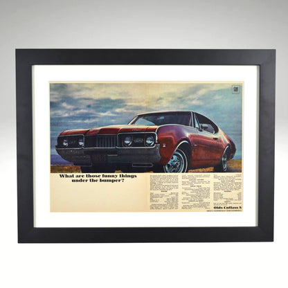 Framed vintage print of the 1968 Oldsmobile Cutlass S, showcasing its forced air induction system under the bumper, sleek design, and bold performance styling.