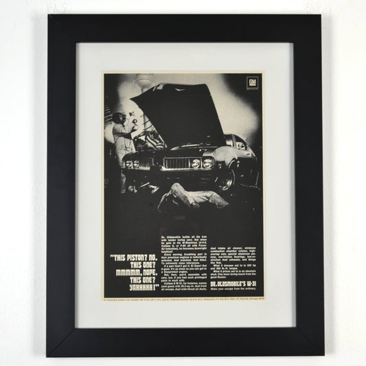 Framed 1969 Oldsmobile W-31 ad print with Dr. Oldsmobile inspecting pistons – 12x15 vintage car wall art

